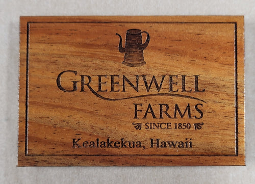 A wooden plaque featuring the engraved logo and text for Greenwell Farms